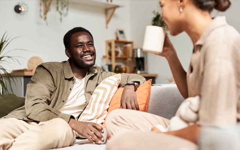 a man and a woman talking on a couch