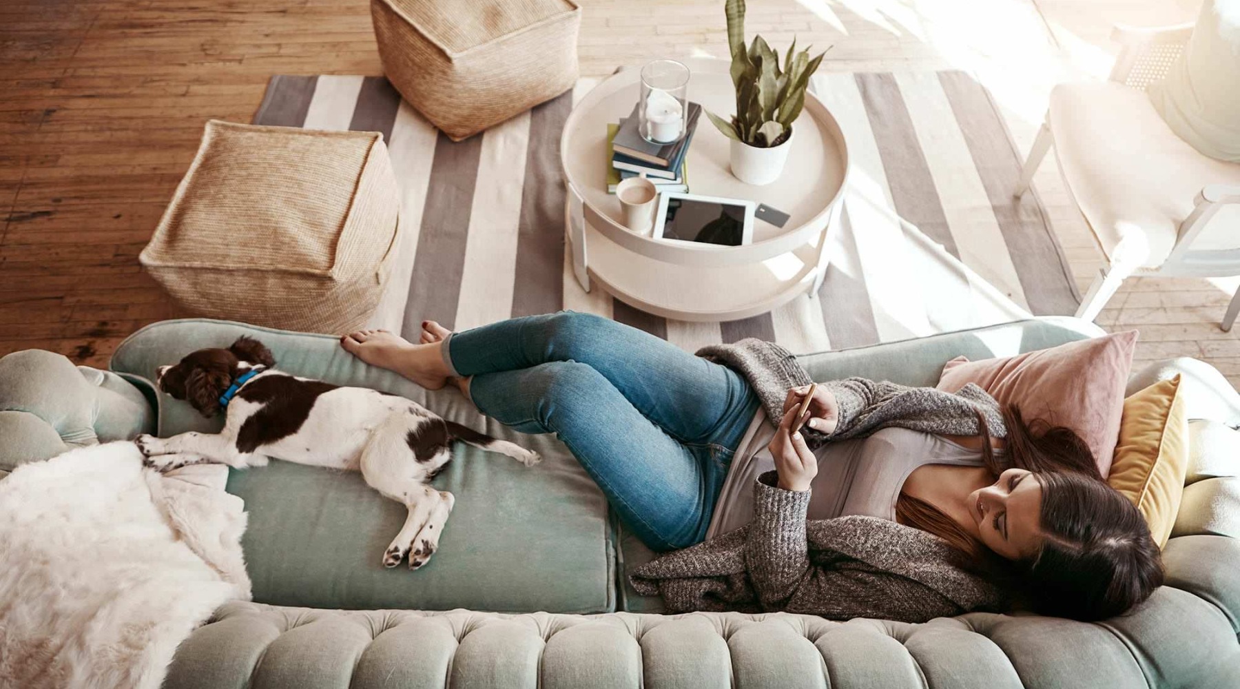 a woman and a dog sitting on a couch