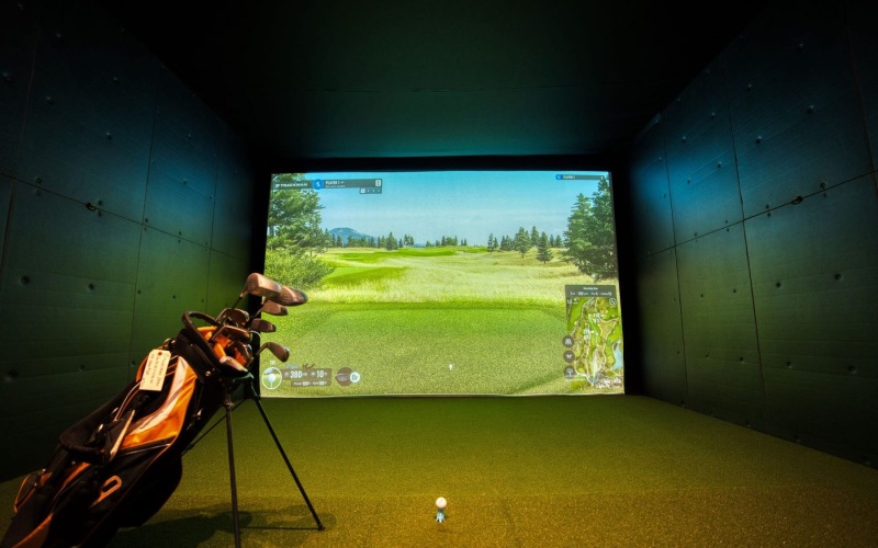 a golf simulator with golf clubs